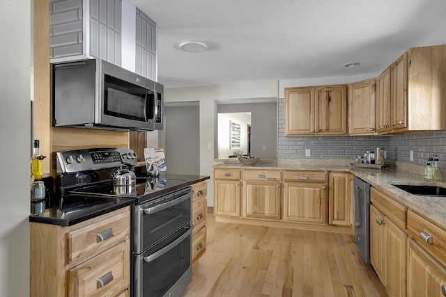16 Gin Mill Ln, Windham, ME 04062 - kitchen featuring appliances with stainless steel finishes, a sink, decorative backsplash, light wood-style floors, and light brown cabinets