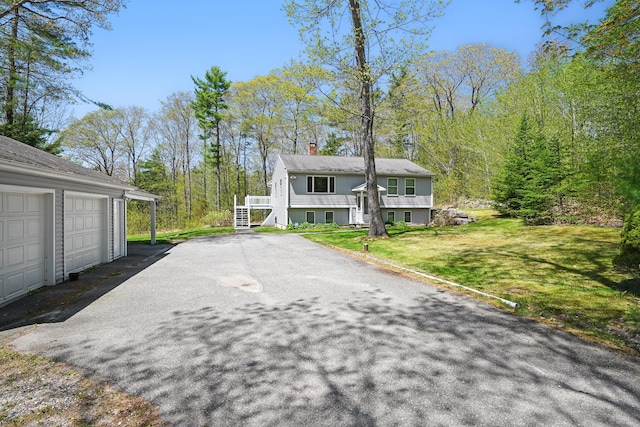 15 Northwood Ct, Wiscasset, ME 04578 - view of front of home featuring a chimney, a front lawn, and stairs