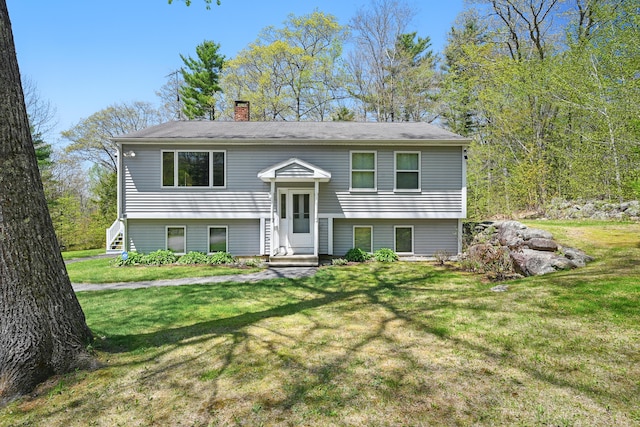 15 Northwood Ct, Wiscasset, ME 04578 - split foyer home with a chimney and a front lawn