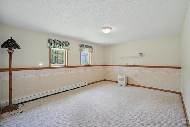 15 Northwood Ct, Wiscasset, ME 04578 - spare room featuring a baseboard heating unit, carpet floors, and a textured ceiling
