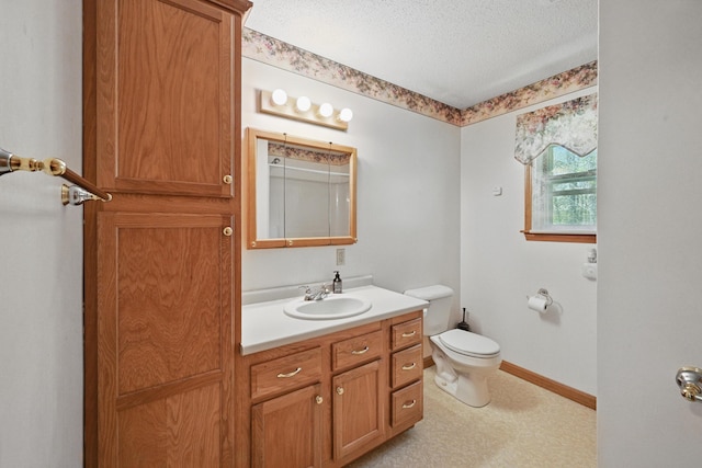 15 Northwood Ct, Wiscasset, ME 04578 - bathroom featuring toilet, a textured ceiling, vanity, and baseboards