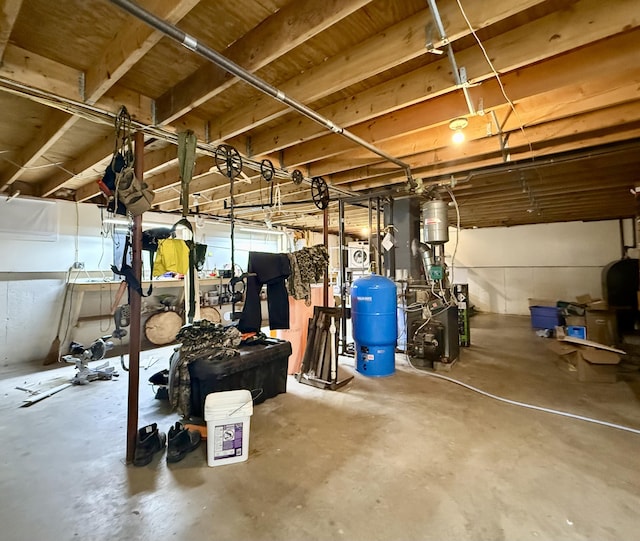 below grade area featuring a water pressure tank and a heating unit