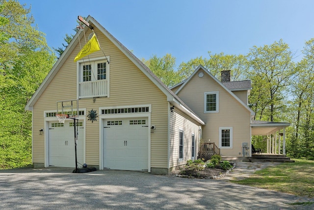 76 Asbury Ln, Acton, ME 04001 - view of side of home with a garage and a chimney