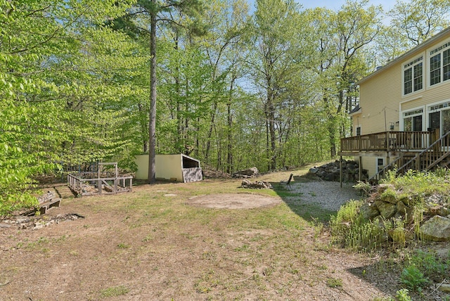 76 Asbury Ln, Acton, ME 04001 - view of yard featuring a wooden deck, stairs, and an outbuilding