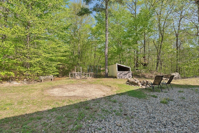 76 Asbury Ln, Acton, ME 04001 - view of yard featuring an outbuilding and a wooded view