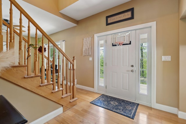 76 Asbury Ln, Acton, ME 04001 - entrance foyer featuring baseboards, wood-type flooring, and stairs