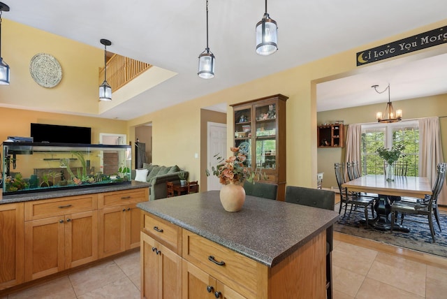 76 Asbury Ln, Acton, ME 04001 - kitchen featuring dark countertops, light tile patterned floors, a kitchen island, and open floor plan