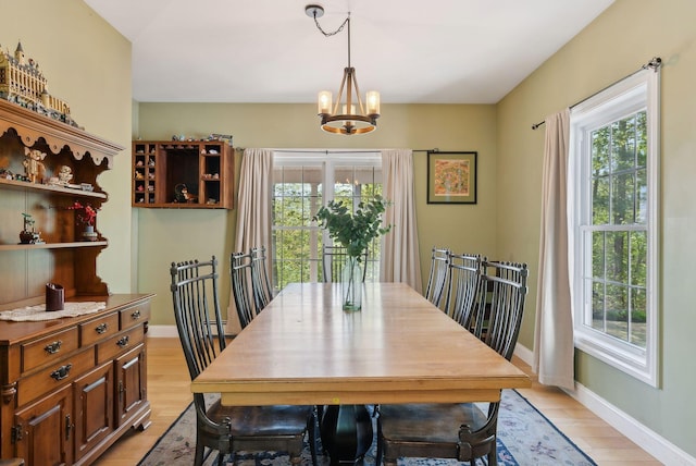 76 Asbury Ln, Acton, ME 04001 - dining area featuring healthy amount of natural light, a chandelier, and light wood-type flooring