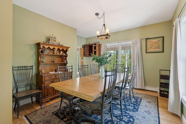 76 Asbury Ln, Acton, ME 04001 - dining space with healthy amount of natural light, light wood-type flooring, a chandelier, and a baseboard radiator