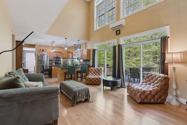 76 Asbury Ln, Acton, ME 04001 - living area with an AC wall unit, light wood finished floors, and a towering ceiling