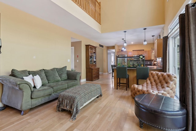76 Asbury Ln, Acton, ME 04001 - living room with a high ceiling and light wood-style floors