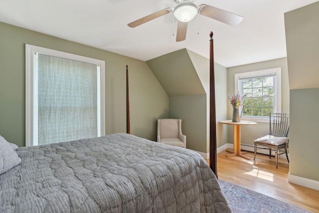 76 Asbury Ln, Acton, ME 04001 - bedroom featuring a baseboard heating unit, light wood-style flooring, baseboards, a ceiling fan, and vaulted ceiling