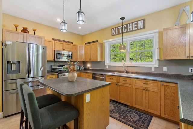 76 Asbury Ln, Acton, ME 04001 - kitchen with appliances with stainless steel finishes, a sink, dark countertops, a kitchen island, and recessed lighting