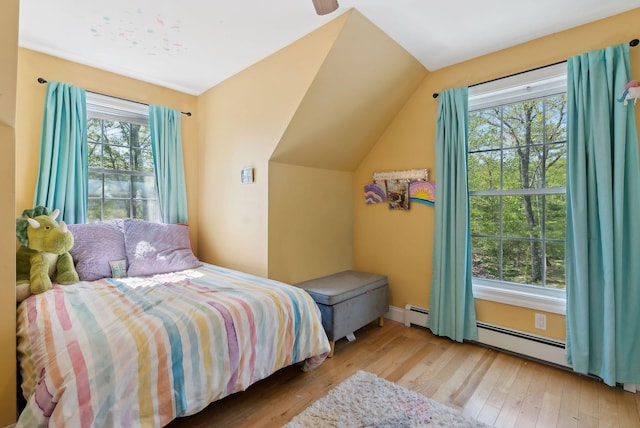 76 Asbury Ln, Acton, ME 04001 - bedroom featuring a baseboard radiator, hardwood / wood-style flooring, and vaulted ceiling