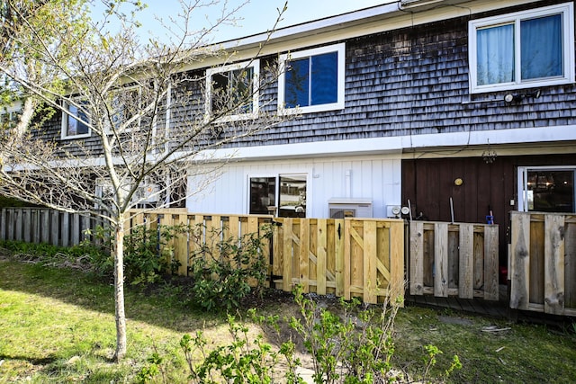 57 Mountfort St, Portland, ME 04101 - rear view of property featuring fence and mansard roof