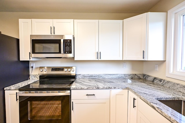 57 Mountfort St, Portland, ME 04101 - kitchen featuring stainless steel appliances and white cabinets