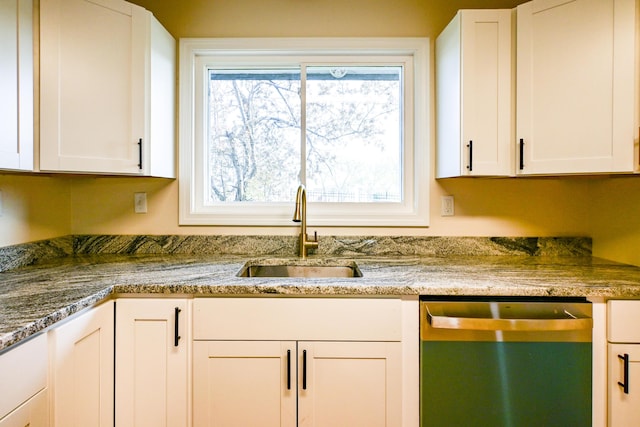57 Mountfort St, Portland, ME 04101 - kitchen with stainless steel dishwasher, a sink, white cabinetry, and stone countertops