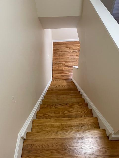 57 Mountfort St, Portland, ME 04101 - stairs featuring wood finished floors and baseboards