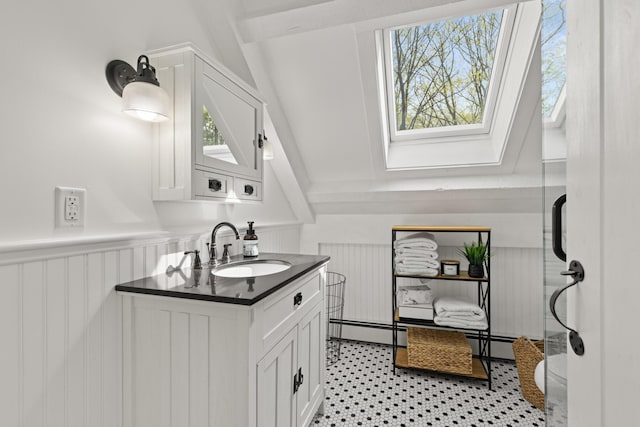bathroom with a skylight, vanity, plenty of natural light, and baseboard heating
