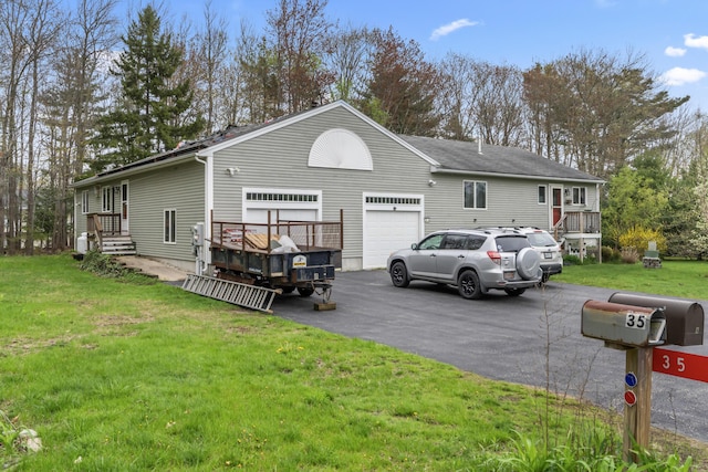 35 Burnt Mill Rd Unit B, Wells, ME 04090 - rear view of house with asphalt driveway, a yard, and a wooden deck
