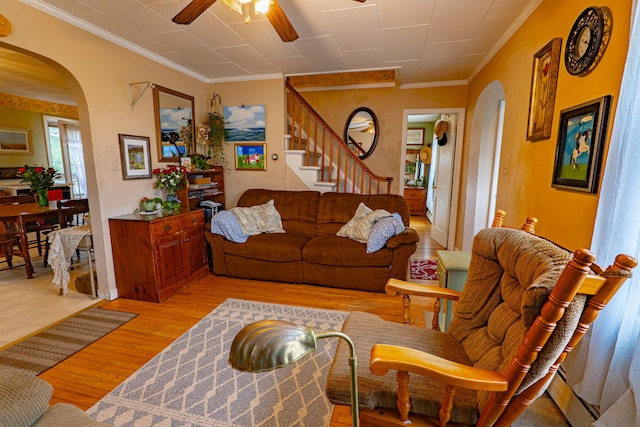 40 Merrow Rd, Auburn, ME 04210 - living room featuring arched walkways, light wood finished floors, crown molding, ceiling fan, and stairs