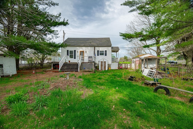 40 Merrow Rd, Auburn, ME 04210 - rear view of property with a fenced backyard, a shed, a wooden deck, an outbuilding, and stairway