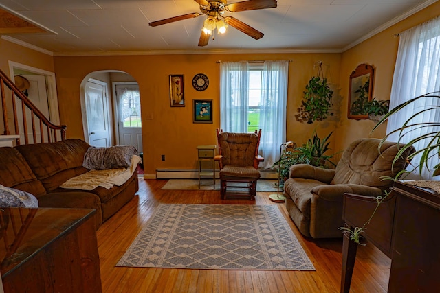 40 Merrow Rd, Auburn, ME 04210 - living room with arched walkways, hardwood / wood-style floors, plenty of natural light, baseboard heating, and ornamental molding