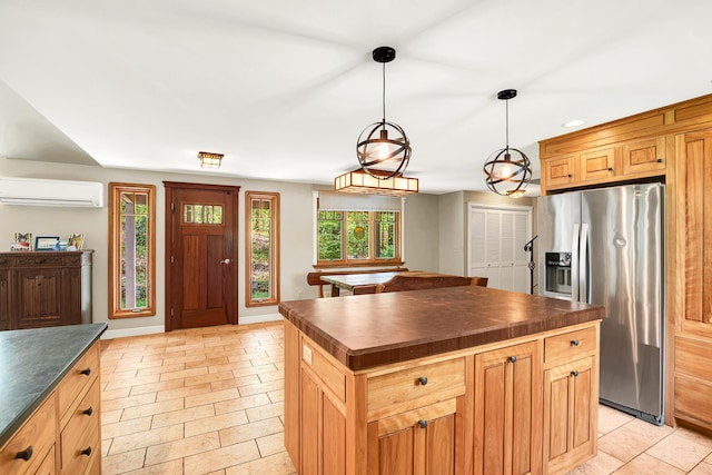 43 Creek Xing, Eliot, ME 03903 - kitchen with stainless steel fridge, a wall unit AC, wood counters, a center island, and hanging light fixtures