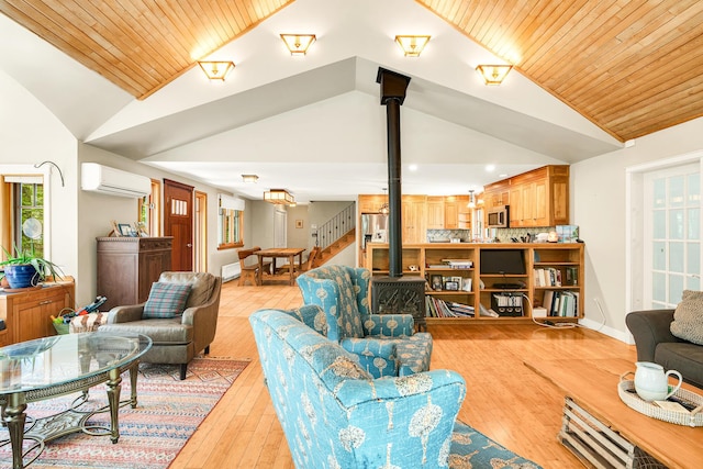 43 Creek Xing, Eliot, ME 03903 - living area with a wood stove, a wall mounted AC, lofted ceiling, light wood finished floors, and recessed lighting