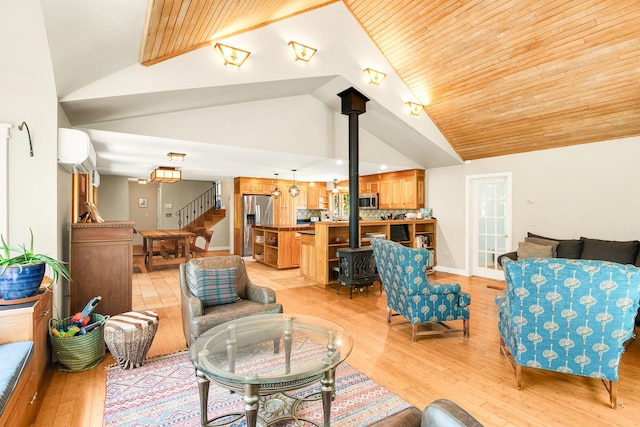 43 Creek Xing, Eliot, ME 03903 - living area with a wood stove, a wall mounted AC, light wood-type flooring, stairway, and wood ceiling