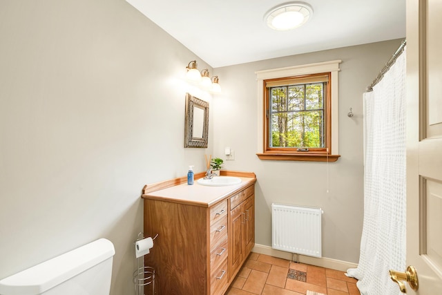 43 Creek Xing, Eliot, ME 03903 - bathroom featuring radiator heating unit, baseboards, toilet, vanity, and tile patterned floors