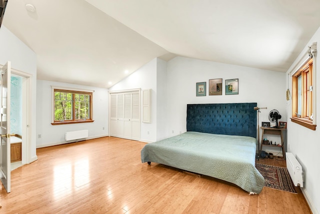 43 Creek Xing, Eliot, ME 03903 - bedroom with lofted ceiling, wood finished floors, radiator heating unit, a closet, and baseboards