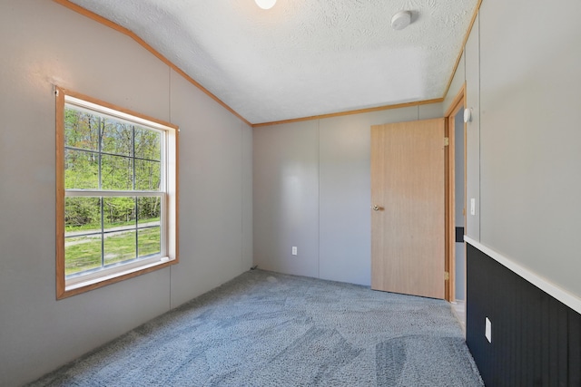 54 Whitten Rd, Clinton, ME 04927 - unfurnished bedroom with lofted ceiling, a textured ceiling, and carpet floors