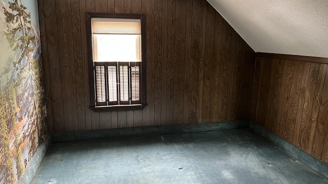 706 Crescent Ave, Rumford, ME 04276 - additional living space with carpet floors, wood walls, lofted ceiling, and a textured ceiling