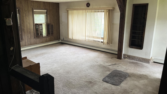 706 Crescent Ave, Rumford, ME 04276 - carpeted spare room featuring a baseboard radiator, baseboards, a textured wall, and wood walls