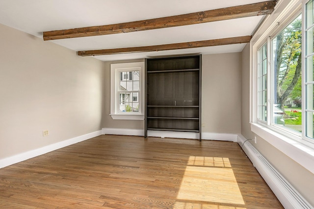 456 Ferry Rd, Saco, ME 04072 - unfurnished bedroom with a baseboard heating unit, beam ceiling, baseboards, and light wood-type flooring