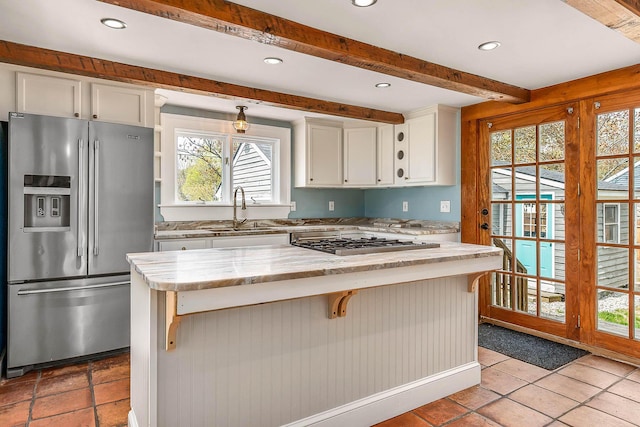 456 Ferry Rd, Saco, ME 04072 - kitchen featuring stainless steel fridge with ice dispenser, gas cooktop, a sink, beam ceiling, and white cabinetry