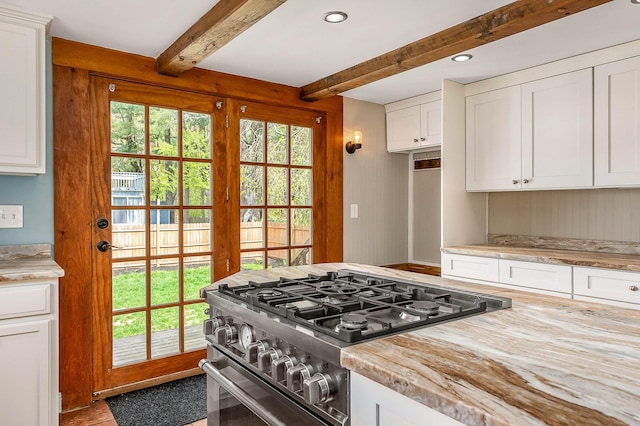 456 Ferry Rd, Saco, ME 04072 - kitchen with stainless steel stove, beamed ceiling, light countertops, and white cabinets