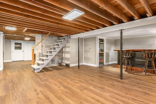456 Ferry Rd, Saco, ME 04072 - finished basement featuring a bar, stairs, baseboards, and wood finished floors