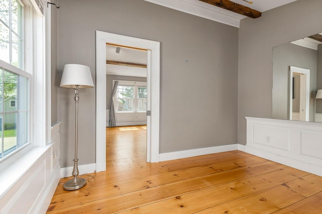 456 Ferry Rd, Saco, ME 04072 - empty room with beam ceiling, baseboards, light wood-style floors, and ornamental molding