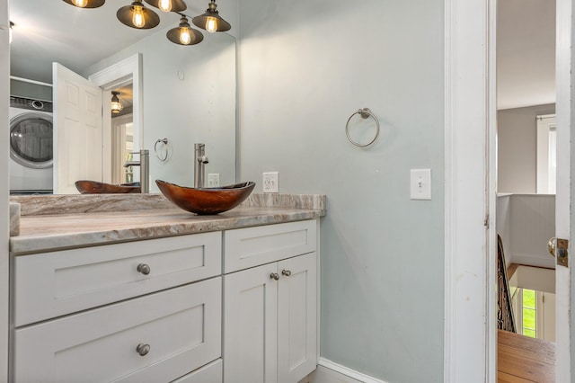 456 Ferry Rd, Saco, ME 04072 - bathroom featuring washer / dryer, vanity, and baseboards