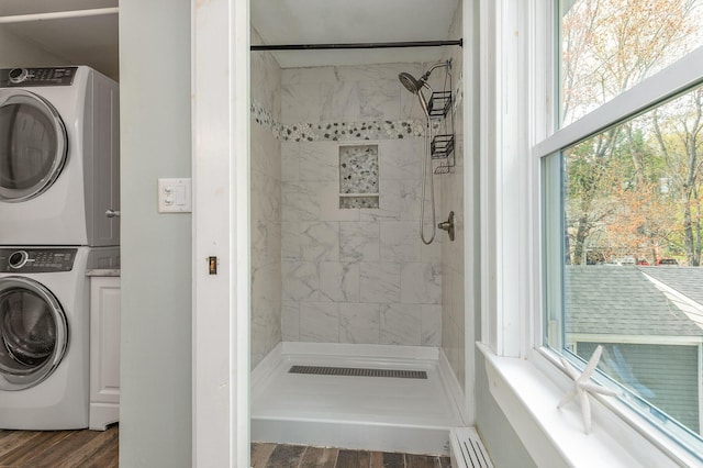 456 Ferry Rd, Saco, ME 04072 - full bathroom with estacked washer and dryer, a stall shower, and wood finished floors
