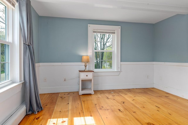 456 Ferry Rd, Saco, ME 04072 - empty room featuring a baseboard radiator, light wood-style flooring, and baseboards