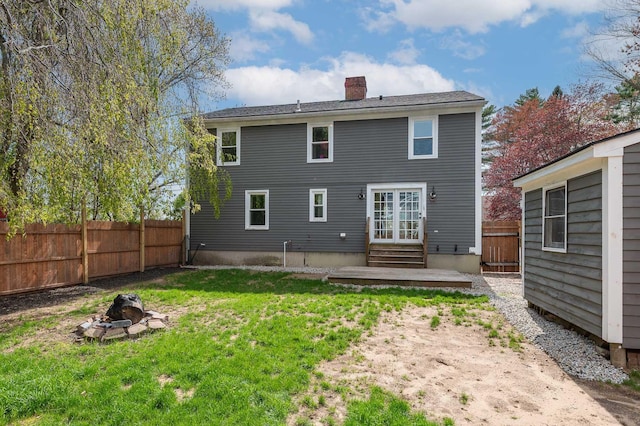 456 Ferry Rd, Saco, ME 04072 - back of property with an outdoor fire pit, entry steps, and a chimney