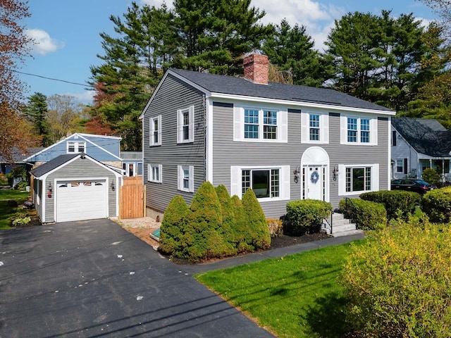 456 Ferry Rd, Saco, ME 04072 - colonial inspired home with a chimney, driveway, and a detached garage