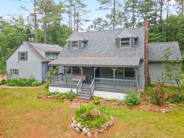 184 Long St, Limerick, ME 04048 - view of front of home featuring a chimney, roof with shingles, a front yard, and a porch