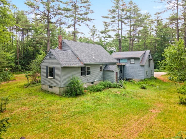 184 Long St, Limerick, ME 04048 - back of property with a chimney, a lawn, and roof with shingles