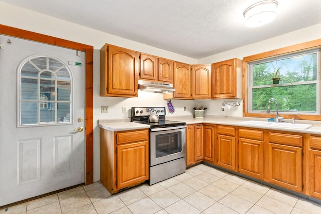 184 Long St, Limerick, ME 04048 - kitchen with stainless steel range with electric cooktop, under cabinet range hood, light countertops, and a textured ceiling