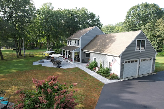 7 Passby Point Rd, Windham, ME 04062 - view of front of home with a garage, a front lawn, a patio, view of wooded area, and roof with shingles