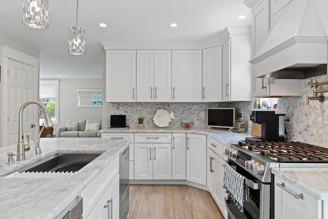7 Passby Point Rd, Windham, ME 04062 - kitchen with appliances with stainless steel finishes, custom exhaust hood, a sink, white cabinetry, and decorative backsplash
